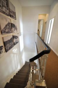 a staircase in a building with pictures on the wall at Hotel Belsoggiorno in Quercianella