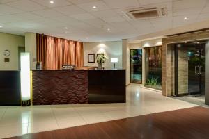 an office lobby with a reception desk in a building at The Oasis in Upington