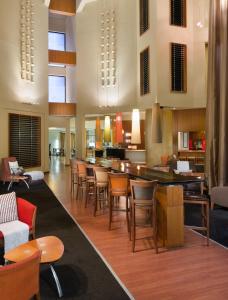 a lobby with a bar with chairs and tables at The Oasis in Upington
