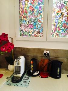 a kitchen counter with a toaster and a stained glass window at Appartment Le Charme du Bourgeois in Nice