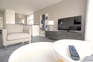 a living room with a tv and a remote control on a table at Huge 3 bedroom apartment in Jordaan near CS in Amsterdam