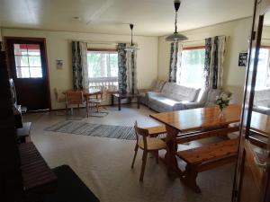 a living room with a table and a couch at Lomakoivulehto in Saarijärvi