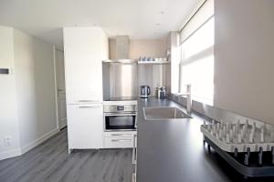 a kitchen with a sink and a stove top oven at Huge 3 bedroom apartment in Jordaan near CS in Amsterdam