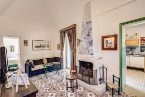 a living room with a couch and a fireplace at B&B "i Magi" in Anacapri +100 photos