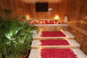 a set of stairs with red plants and lights at Jaypee Siddharth in New Delhi