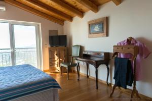 a bedroom with a bed and a desk with a computer at Villa Mos in Kalamata