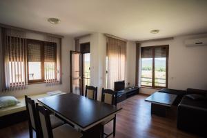 a living room with a table and a couch at Guest House Georgievi in Primorsko