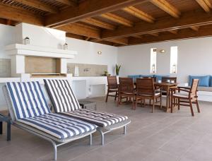 a living room with a dining room table and chairs at Luxury Villa Verna in Líndos