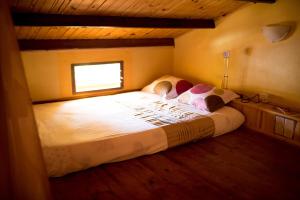 a bedroom with a large bed in a room at Le Chateau du Lac de Mantasoa in Mantasoa