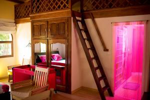 a bedroom with a bunk bed with pink lighting at Le Chateau du Lac de Mantasoa in Mantasoa