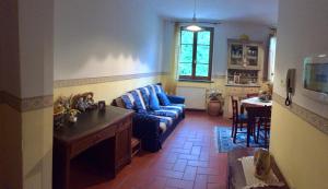 a living room with a blue couch and a table at La Casetta Di Chichi E Lory in Stazzema