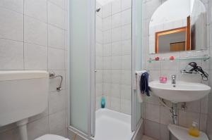 a bathroom with a shower and a toilet and a sink at Apartments Mira in Tribunj +76 photos