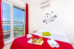 a bedroom with a bed with a tray of food on it at Apartments Pava in Okrug Donji