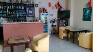 a restaurant with a bar and a table and chairs at Guest House Tony in Nesebar