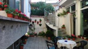 an alley with a table and chairs and potted plants at Guest House Tony in Nesebar +19 photos