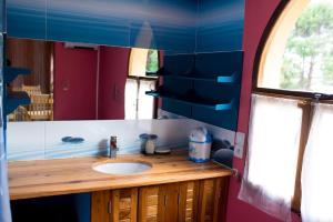 a bathroom with a sink and a mirror at Le Chateau du Lac de Mantasoa in Mantasoa +21 photos