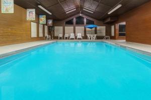 a large pool with blue water in a hotel room at Days Inn by Wyndham Sidney NE in Sidney