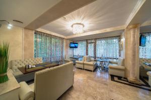 a large living room with couches and a television at Boutique Hotel Boulevard in Yalta
