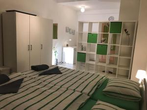a bedroom with a large bed with green sheets at Big Homebase with Billardtable in Prague