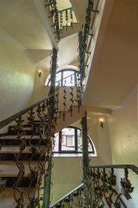 a spiral staircase in a building with a window at Boutique Hotel Boulevard in Yalta
