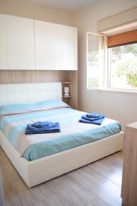 a bedroom with a bed with blue towels on it at Stefy Home in Catania