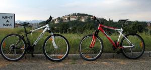 two bikes parked next to each other on a road at Apartma Furlan in Štanjel