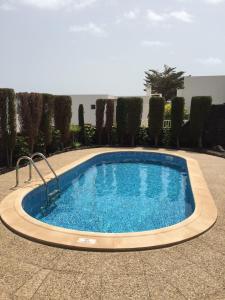 a large swimming pool in a tile yard at Villa Benita II in Playa Blanca