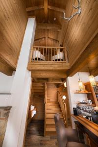 an attic room with a wooden ceiling and a staircase at Lehenriedl Chalet in Wagrain +45 photos