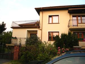 a house with a car parked in front of it at Pokoje Gościnne Lawenda in Sandomierz
