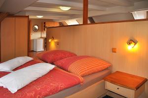 a bedroom with two beds on a boat at Apartmány Rosalka in Stará Oleška