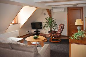 a living room with a couch and a table at Apartmány Rosalka in Stará Oleška
