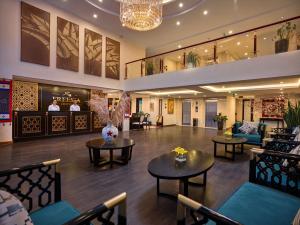 a lobby of a hotel with tables and chairs at Sapa Freesia Hotel in Sa Pa