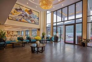a lobby with couches and tables in a building at Sapa Freesia Hotel in Sa Pa