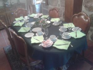 a dining room table with a blue table cloth and chairs at Casas Vale Martinho in Santa Comba Dão