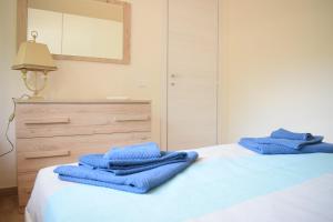 two blue towels are sitting on top of a bed at Stefy Home in Catania