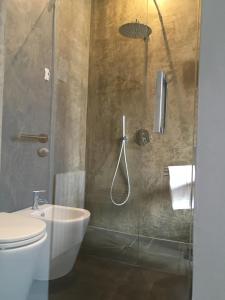 a bathroom with a toilet and a shower stall at Dimora Villareale in Palermo