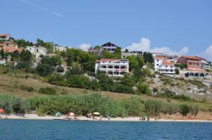 a group of people on a beach near the water at Apartments Smokvica I in Smokvica