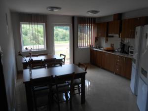 a kitchen and dining room with a table and chairs at Halasto Pension in Praid +36 photos