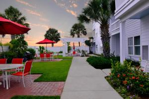 a patio with a table and chairs and the ocean at Lighthouse Inn at Aransas Bay in Rockport