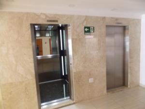 a room with a glass door in a building at Apto Praia Grande - Guilhermina in Praia Grande