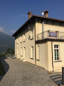 a building with a balcony on the side of it at La Vecchia Scuola in Villa Dalegno