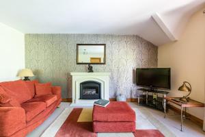 a living room with a couch and a fireplace at Titanic View Luxury Apartment Belfast in Belfast