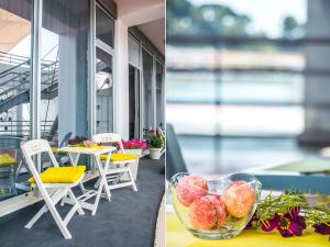 two pictures of a table and chairs and a bowl of fruit at IDRO Studio Apartments directly at the beach in Split