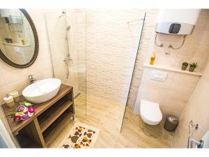 a bathroom with a sink and a glass shower at IDRO Studio Apartments directly at the beach in Split