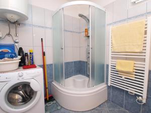 a bathroom with a shower and a washing machine at Apartment Marija 1389 in Fažana +21 photos