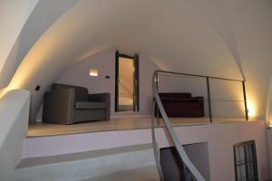 a living room filled with furniture and a large window at Aria Suites & Villas in Fira