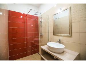 a bathroom with a sink and a shower with a mirror at IDRO Studio Apartments directly at the beach in Split