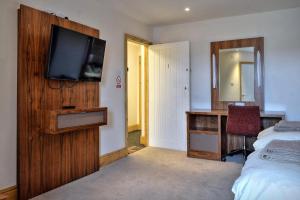 a bedroom with a bed and a television on a wall at The Wharf Stourport in Stourport