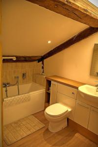 a bathroom with a toilet and a tub and a sink at The Wharf Stourport in Stourport