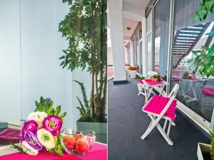 a pink table with flowers on top of a building at IDRO Studio Apartments directly at the beach in Split